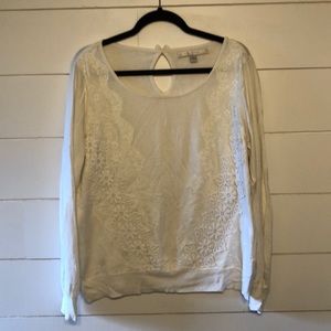 White sweater with lace details.